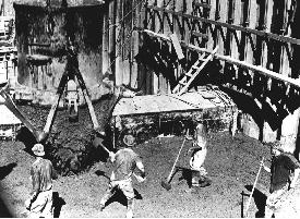 Photo of puddlers working with concrete.